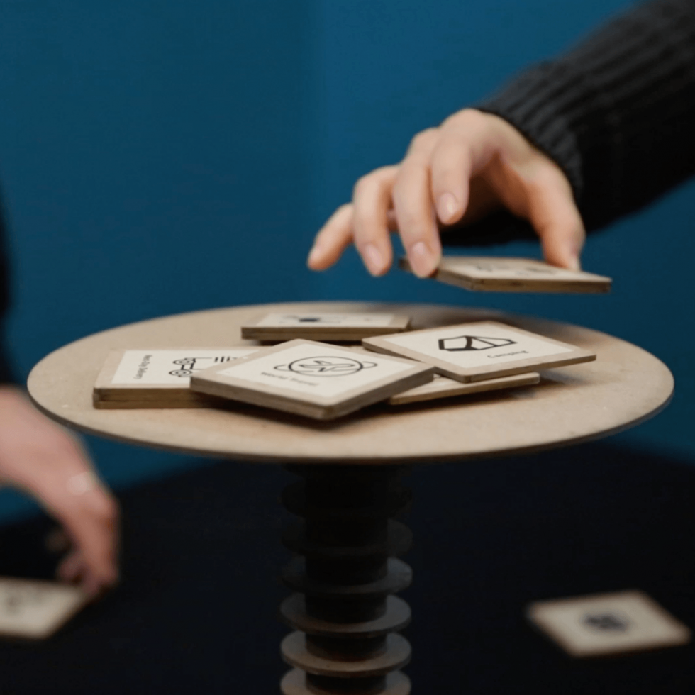 A player places a tile on top of an elevated disc.